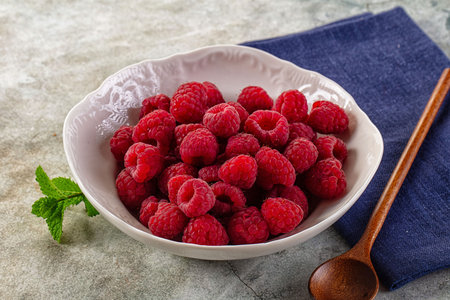 Organic ripe sweet juicy raspberry in the bowl