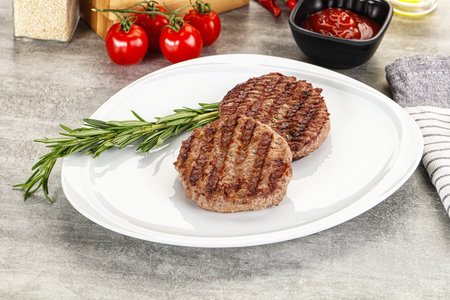 Grilled two beef burger cutlet served rosemary