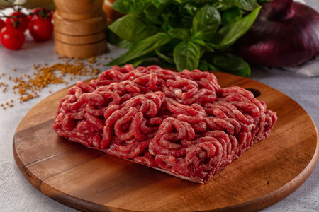 Raw minced beef meat over board for cooking