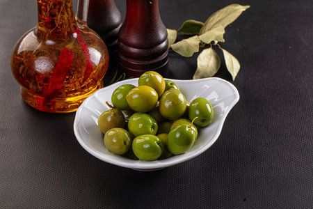 Marinated pickled green olives snack in the bowlの写真素材