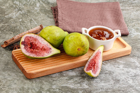 Tropical exotic green fig with cut over boardの写真素材