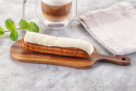 White delicous vanilla eclair with icing dessert