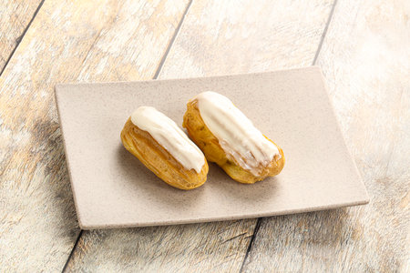 Delicious tasty eclair with ising and creamの写真素材