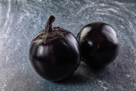 Raw roundripe black big eggplantの写真素材
