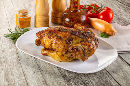 Baked in oven whole chicken with spices and herbsの写真素材