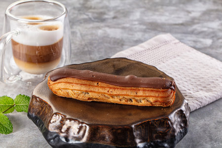 Gourmet chocolate eclair with brown icing