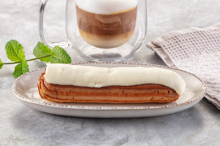 White delicous vanilla eclair with icing dessert