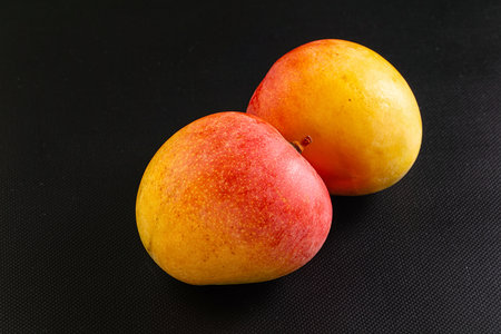 Sweet ripe juicy red fresh mangoの写真素材