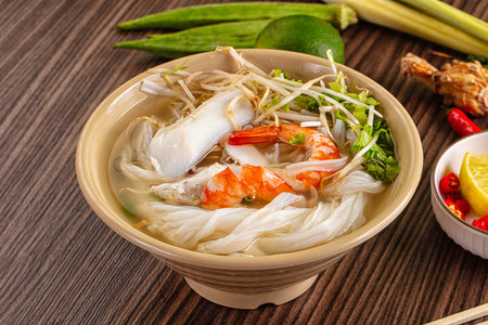 Vietnamese soup Pho with seafood - prawn and calamari