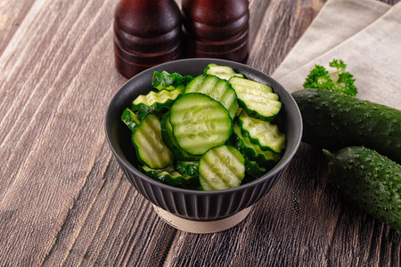 Fresh green ripe cucumber slices in the bowlの写真素材