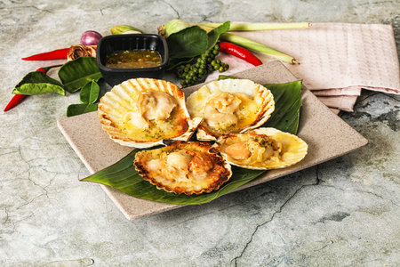 Griiled scallops in shell with cheese served sauceの写真素材