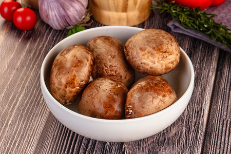 Raw brown champignon heap in the bowl for cookingの写真素材