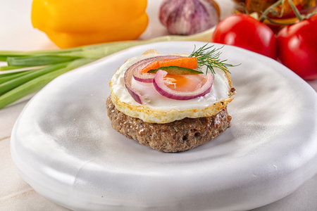 Beefsteak chop minced meat with roasted eggの写真素材