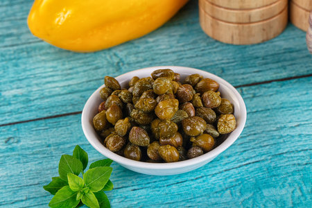 Pickled canned capers snack antipasti in the bowl