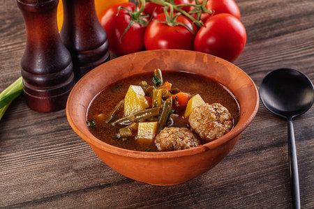 Tomato Soup with meatballs, potato. carrot and green beanの写真素材