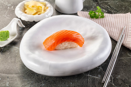 Japanese cuisine - sushi with salmon served yellow gingerの写真素材