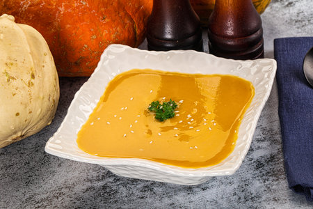Vegan pumpkin cream soup served sesam seeds and parsleyの写真素材