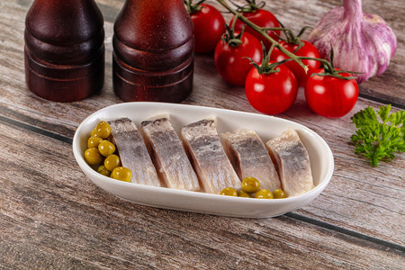 Slided marinated salted herring fillet with green peasの写真素材