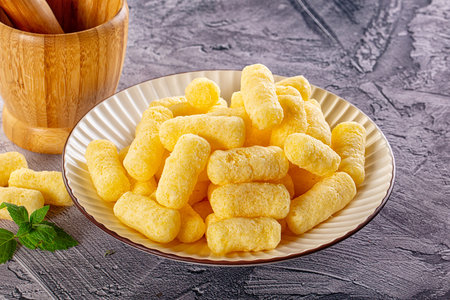 Golden crispy sweet corn sticks in the bowl for snackの写真素材