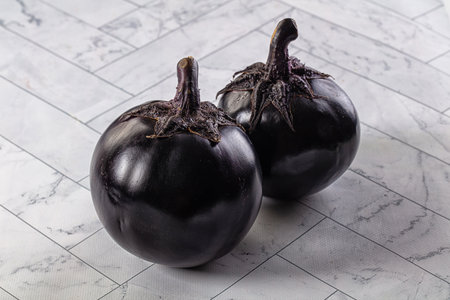 Raw roundripe black big eggplantの写真素材