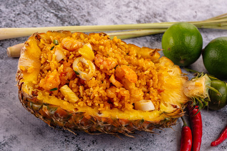 Seafood fried rice in pineapple half with prawn and squidの写真素材