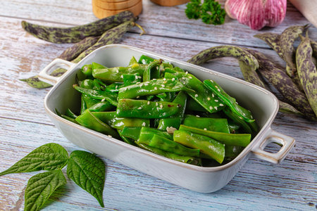 Steamed green bean strings heap with olive oil