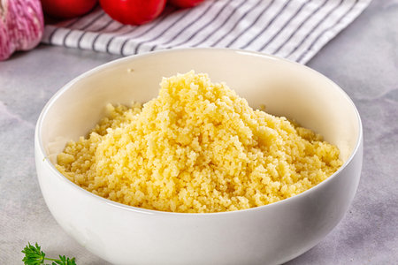 Boiled wheat couscous grain garnish in the bowlの写真素材