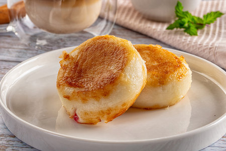 Fried homemade cottage cheese syrniki for breakfast