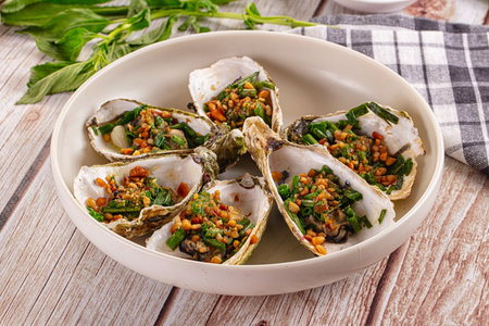 Gournet grilled oysters with green onion and peanutの写真素材