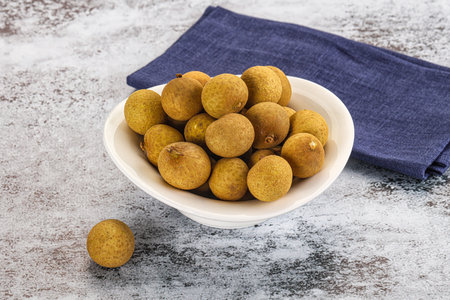 Sweet juicy tropical fruit longan in the bowl
