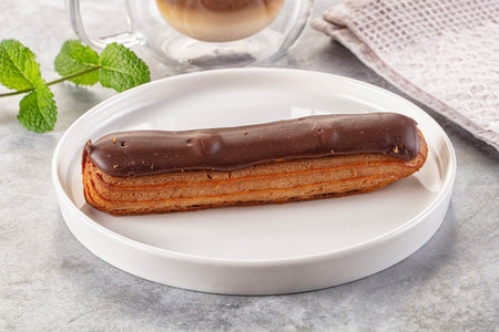 Gourmet chocolate eclair with brown icing