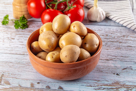 Uncooked raw yellow baby potato in the bowlの写真素材