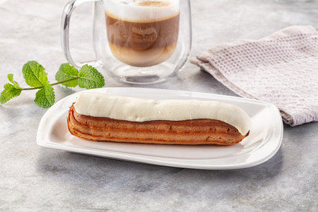 White delicous vanilla eclair with icing dessert