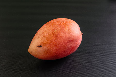 Whole ripe sweet tropical red mango fruit