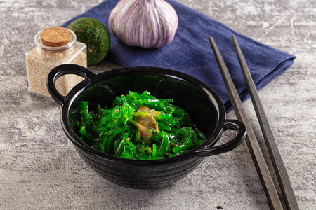 Green raw chuka seaweed salad with sesame sauceの写真素材