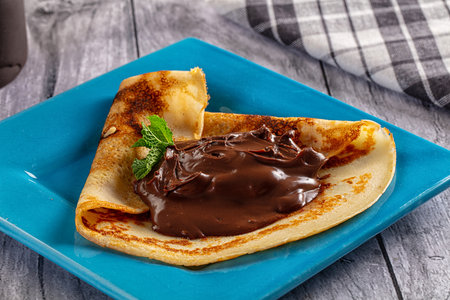 Sweet pancake with chocolate paste for breakfastの写真素材