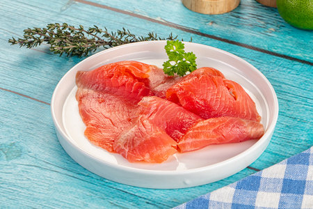 Delicous sliced salmon fillet ready to eat in the plate served thymeの写真素材