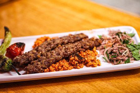 Turkish adana kebab with vegetables and onionの写真素材