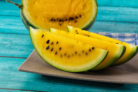 Ripe sweet juicy yellow watermelon with slicesの写真素材