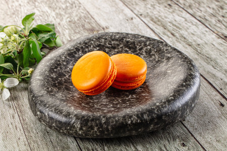 Sweet almond cookies orange macaroons served flowerの写真素材