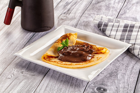 Sweet pancake with chocolate paste for breakfastの写真素材