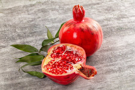 Ripe sweet juicy pomegranate fruit with cutの写真素材