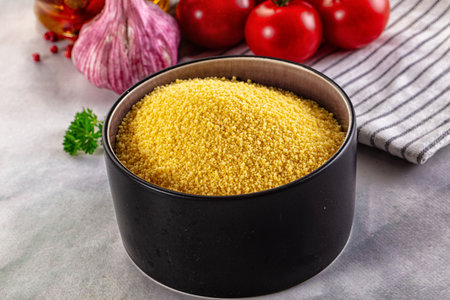 Raw dry couscous in the bowlの写真素材