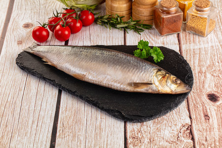 Raw whole salted herring fish served parsleyの写真素材