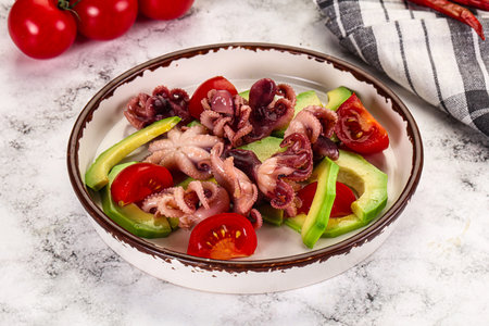 Salad with baby octopus, tomato and avocadoの写真素材