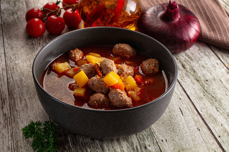 Tomato soup with meatballs and vegetables carrotの写真素材