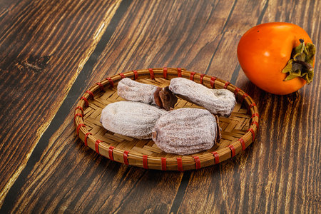 Dry sweet ripe persimmon fruit dessertの写真素材