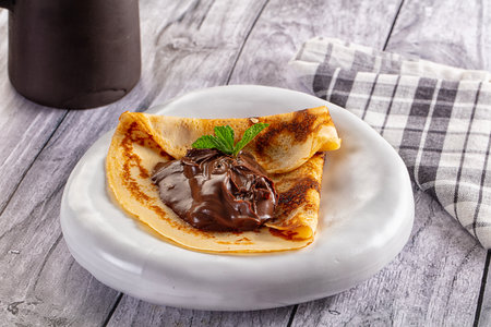 Sweet pancake with chocolate paste for breakfastの写真素材