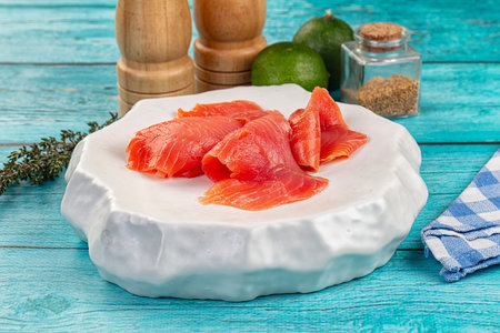 Sliced salmon fillet ready to eat in the plate served thymeの写真素材