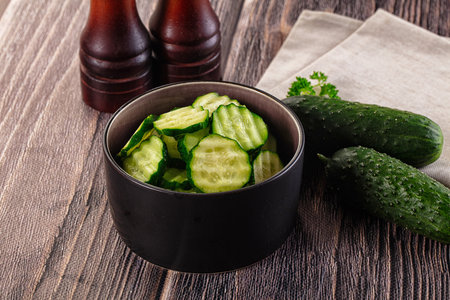 Fresh green ripe cucumber slices in the bowlの写真素材